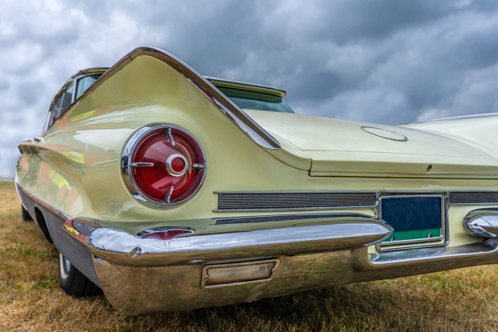 A closeup shot of the back part of a vehicle parked under a cloudy sky