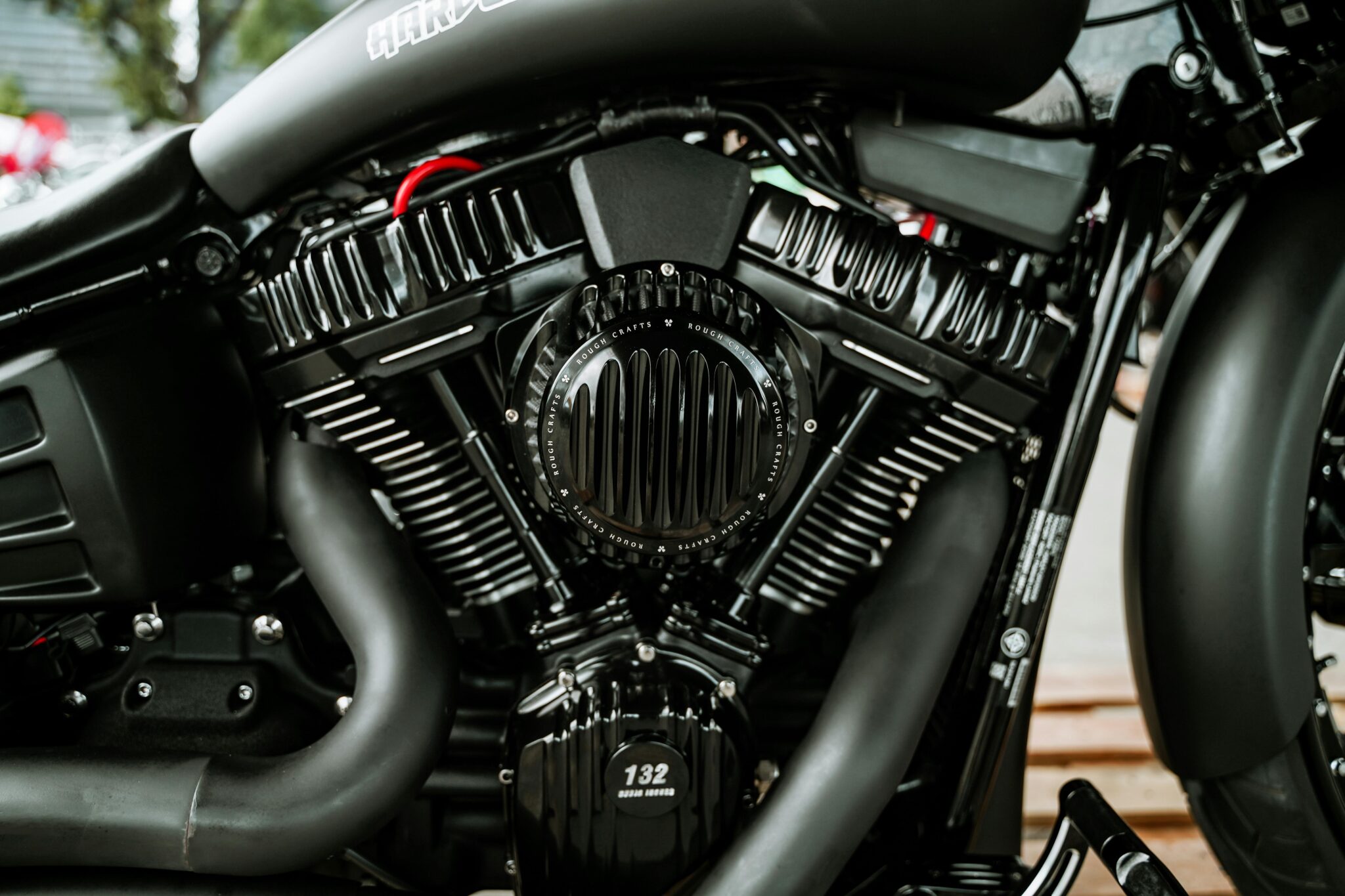Detailed view of a glossy motorcycle engine showcasing mechanical precision and artistry.