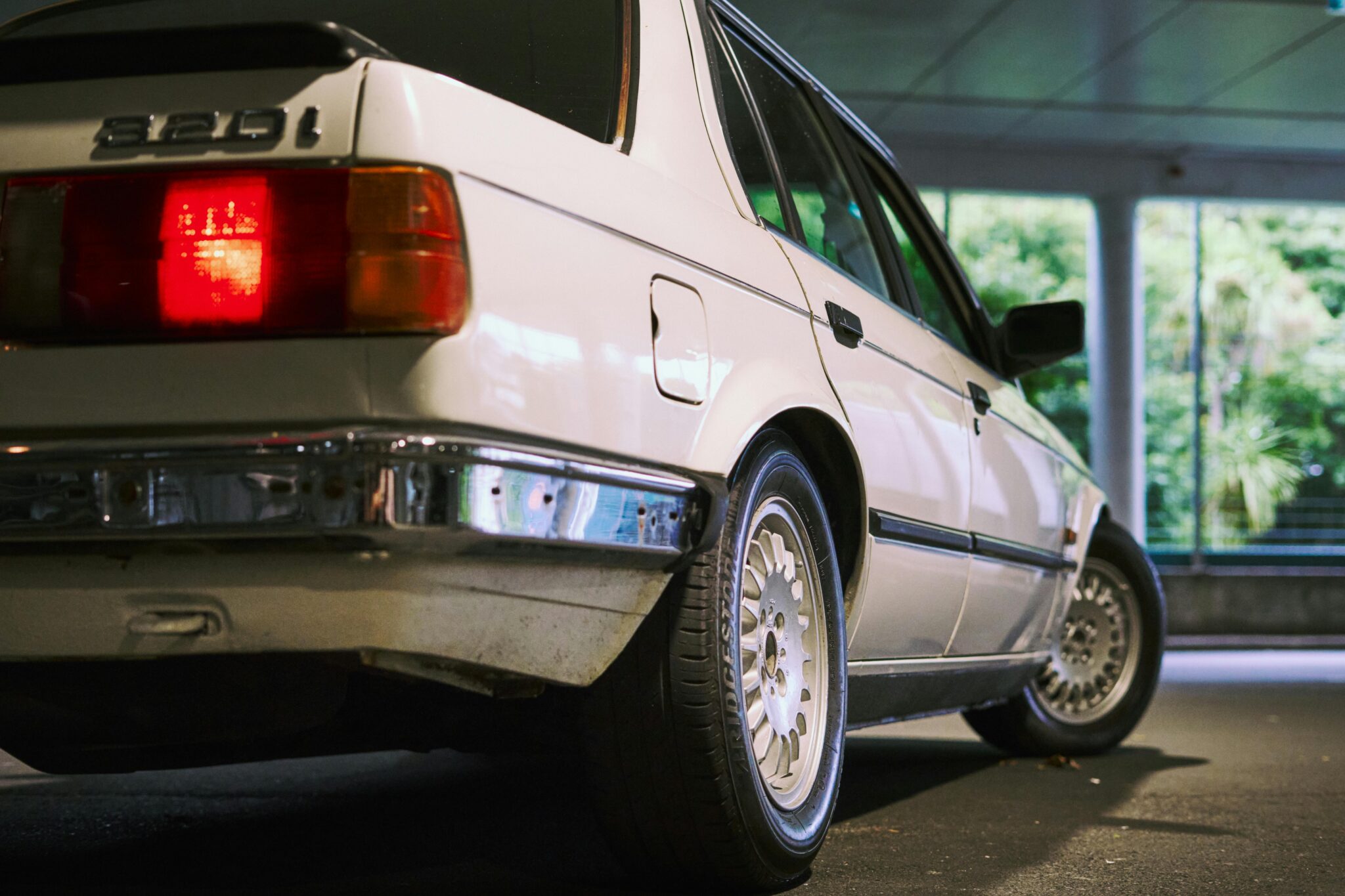 Vintage sedan with modifications parked inside a garage in Auckland, New Zealand.